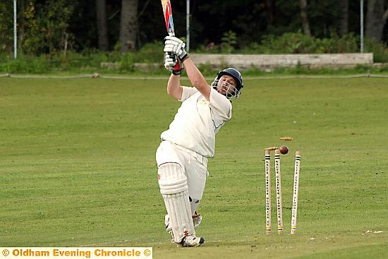 CRASH OF ASH . . . the bails go flying as Heyside’s Ben Holt is bowled. 