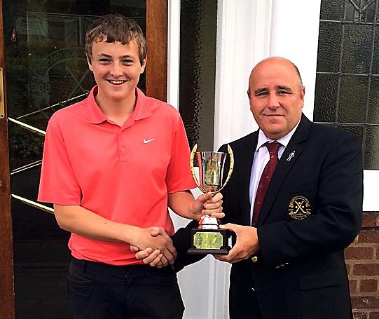 WINNING FEELING: Michael V Smith receives the Chronicle Junior Cup from Crompton and Royton captain Steve Costigan.