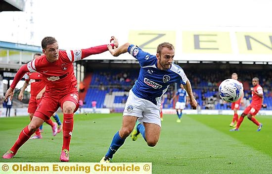 LIAM KELLY, pictured in midfield combat, will be a “great player” for Athletic says manager Lee Johnson.