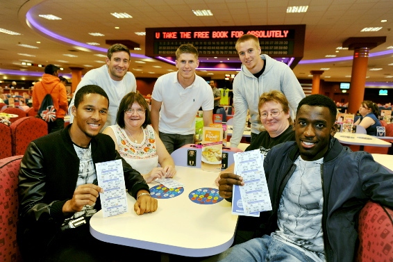 Latics fans Sue Rigby and Stacey Shaw are pictured with (from the left) Timothee Dieng, manager Lee Johnson, Danny Philliskirk, David Mellor and Amari Morgan-Smith.