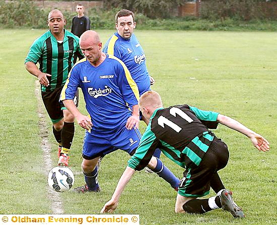 ACTION STATIONS . . . Carrion Crow’s Dean Leach (blue strip) battles for possession. PICTURE: PAUL STERRITT.