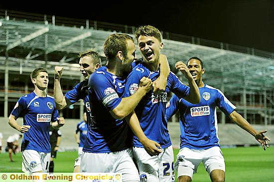 TEENAGE KICKS . . . Jordan Bove gets a hug from skipper Liam Kelly after scoring Athletic’s goal.