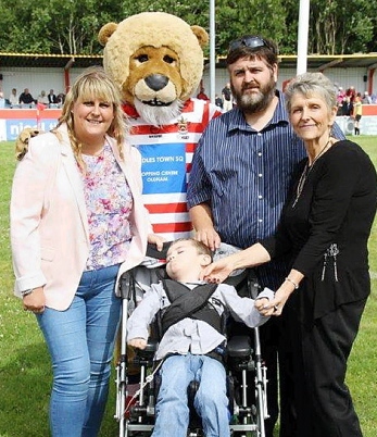 APPEAL . . . Joe Joe with, from left, Andrea McKenna (Joe Joe’s auntie), Oldham RL mascot Roary, Billy Atherton (Joe Joe’s dad) and grandma Marilyn Atherton