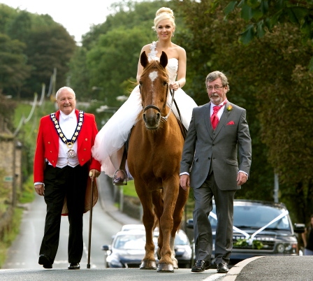 Olivia, escorted by her dad Chris Sunderland (right) and toastmaster William Sheldon. 