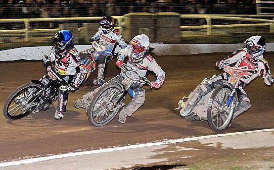 SO CLOSE: Aces’ Craig Cook (blue helmet) leads Poole’s Dakota North (white) in a nail-biting Elite League Grand Final clash. 