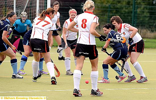 surrounded: Oldham’s Yvonne Jackson has nowhere to go, while Rachael Johnson attempts to dispossess her rival. 
