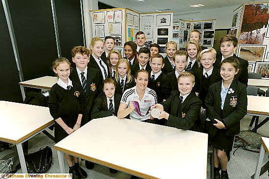 Ben Loftus gets a closer look at Claire Cashmore’s silver medal with his classmates looking on