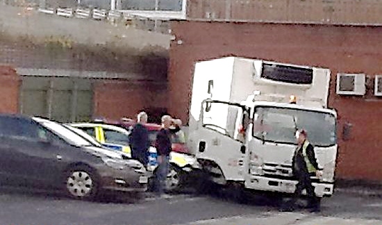 The truck rolled back into the police car
