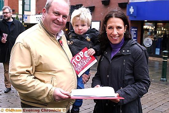 SIGNING the petition . . . Ken Rustidge with his son, Alexander, aged three, and Mrs Abrahams SIGNING the petition . . . Ken Rustidge with his son, Alexander, aged three, and Mrs Abrahams