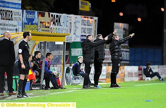 Acting as one . . . from the left, Athletic’s toucline team of David DUnne, Keith Brown and Dean Holden ge their point across.
