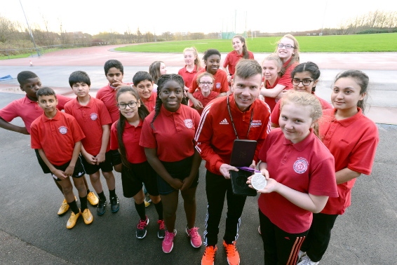 Top class . . . Rick shows off one of the Paralympic medals to pupil Toni Collins.