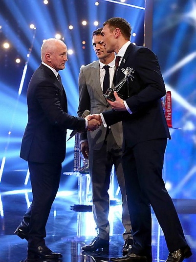 WHAT AN HONOUR: Kevin Sinfield (right) shakes hands with Irish boxing legend Barry McGuigan after receiving his BBC runner-up trophy. WHAT AN HONOUR: Kevin Sinfield (right) shakes hands with Irish boxing legend Barry McGuigan after receiving his BBC runner-up trophy.