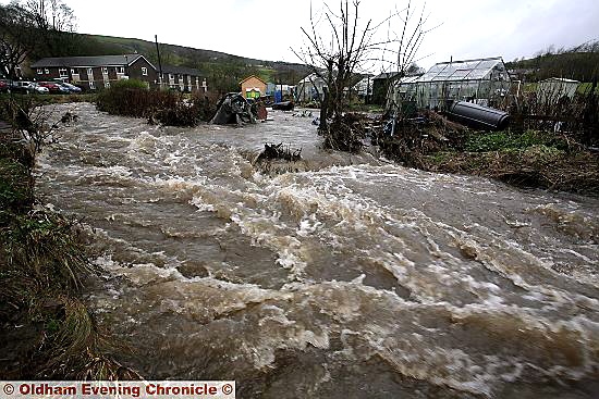 SEVERE torrent . . . the River Tame bursts its banks near Holland Close, Delph. 