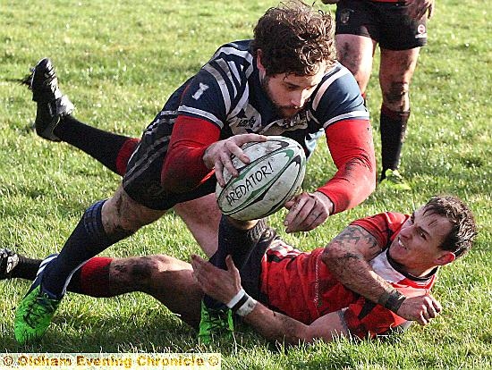 TOUCHING DOWN: Ashley Dixon evades a despairing tackle by a Keighley Albion opponent to score Hollinwood’s opening try