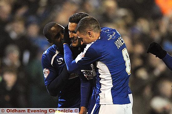 YOU BEAUTY: Conor Wilkinson gets a hug from Jonathan Forte and Mike Jones after doubling Athletic’s lead