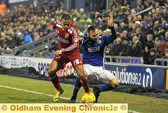 RUNNING BATTLE: Liam Kelly is felled by a challenge from fellow midfielder Louis Thompson.