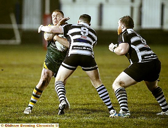 SIMON Topping, of Oldham St Anne’s, runs into an opponent.