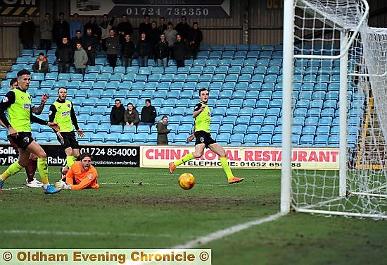 cool as you like: Carl Winchester (right) slots home Athletic’s winner at Glanford Park.