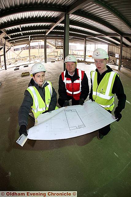 FROM LEFT: Alfredo Lozano (11), Willmott Dixon construction manager Martin Middleton and Ewan Fox (16), get a look at the second floor plans of the sports centre.