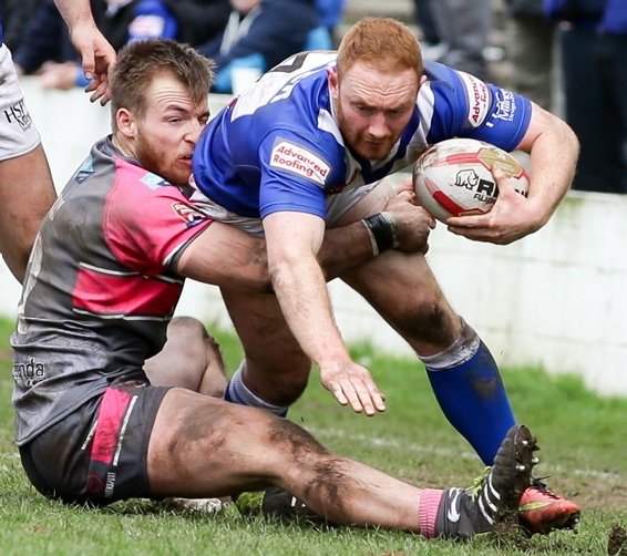 TOTAL COMMITMENT: Adam Clay (left) produces a superb tackle at Barrow.