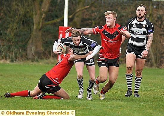 GO FOR IT . . . Josh Brady attempts to burst through two Ince Rose Bridge defenders. 