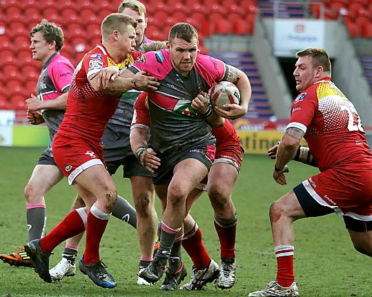 COMING THROUGH . . . ball in hand, Josh Crowley attempts to punch a hole in the Sheffield Eagles line.