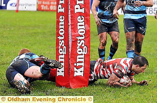 TRY TIME: Oldham stars Adam Neal (right) and Adam Clay cross the line.