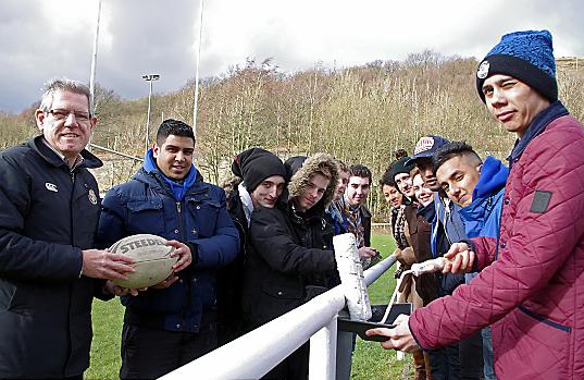 TEAMWORK . . . (from left) Peter Townsend, club secretary at Saddleworth Rangers, and Adeel Abbas, Prince’s Trust team leader at Groundwork, with team members