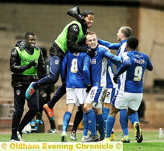 MIKE JONES celebrates his goal with team-mates.
