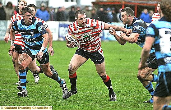 HAND OFF: Oldham prop forward Adam Neal makes a break.