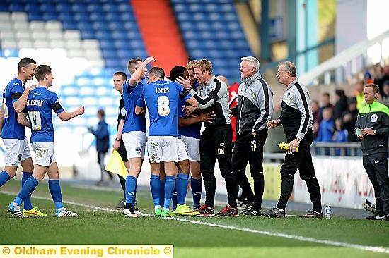 AT THE DOUBLE . . . Dean Holden celebrates with Athletic’s two-goal hero Dominic Poleon.
