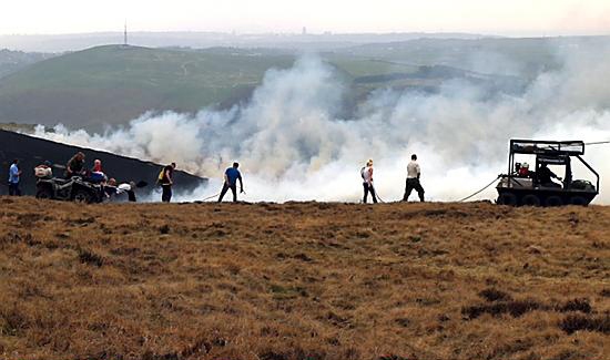 FIREFIGHTERS tackle the wall of smoke and flame