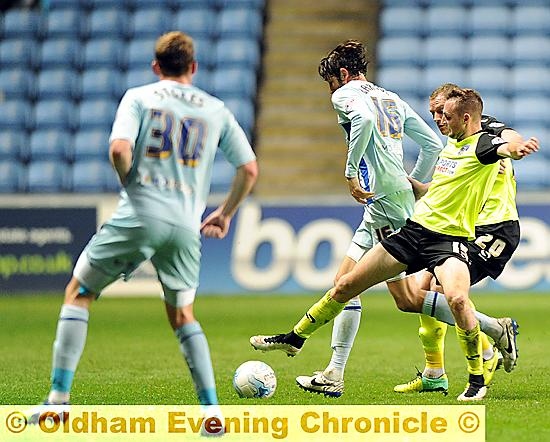 MIDFIELD BATTLE: Carl Winchester puts himself about in a congested area.