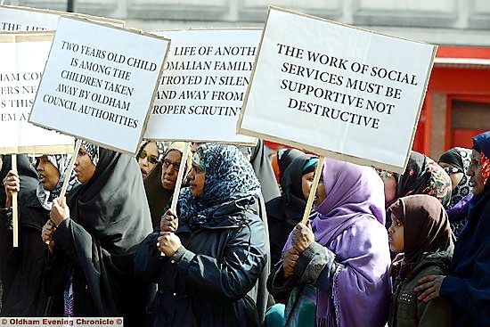 PROTESTERS gather outside Oldham Civic Centre after three children were taken into care