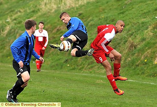 HIGH FLYER: Springhead striker Leighton Stephenson (right) is beaten to the ball.
