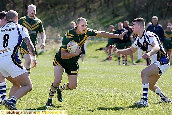 GET AWAY: Alan Williamson, of Saints fends off a would-be Blackbrook tackler. PICTURE: PAUL STERRITT.