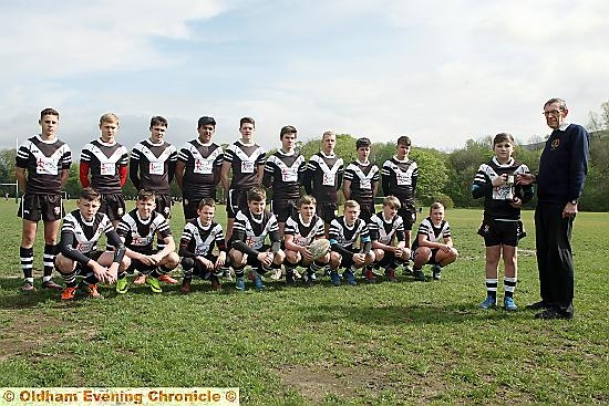 ALL YOURS . . . Rugby Oldham chairman Geoff Cooke presents the Rugby Oldham Junior Club Challenge trophy to Saddleworth Rangers under-15s captain Finn Gallagher. The team are heading to France at the end of the month for a week-long tour.