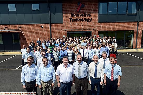 Staff and directors outside the new building . . . (front, from the left) directors Marcus Tiedt, Mustapha Hadj Ahmed, Aidan Towey, David Bellis MBE, TJ Crowley and Alun Evans, with fellow directors Chris Robinson (left) and Tony Morrison immediately behind