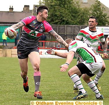 LOOKING FOR SUPPORT: Oliver Roberts prepares to fire out a pass for Oldham at Cougar Park