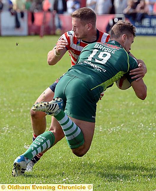 HIT MAN ... dual-reg player Jacob Fairbank puts in a crunching tackle for Oldham