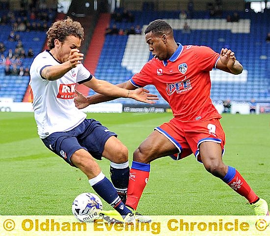 THROUGH HIS LEGS . . . Dominic Poleon makes his presence felt. 