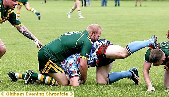 GETTING TO GRIPS . . . Saints’ John Fox stops a Dudley advance. 