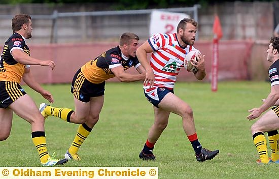 ON THE CHARGE FOR OLDHAM . . . two-try man Josh Crowley attacks the York City Knights line.