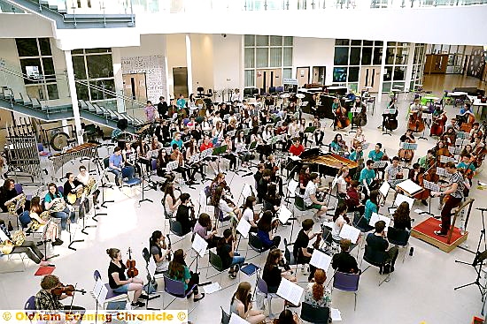 The Orchestra sets up shop in the main hall of Newman College. 