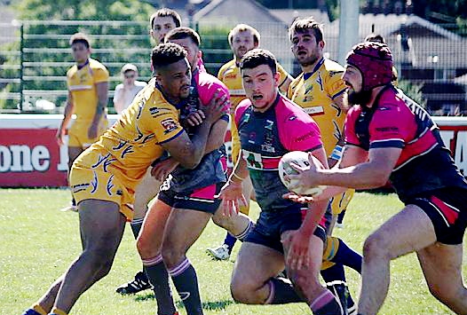 GATHERED SAFELY . . . Michael Ward picks up possession as Oldham mount another attack.