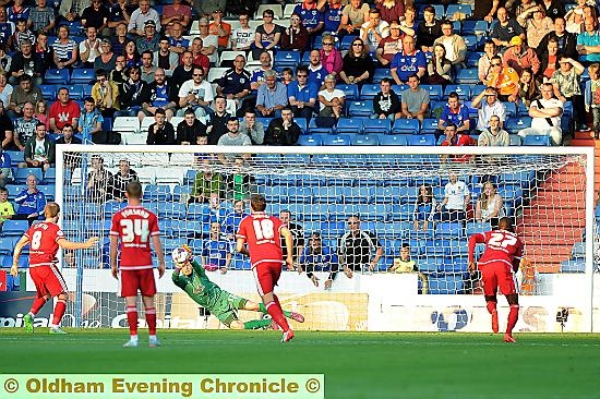 SURE STOP . . . David Cornell dives to his right to keep out Adam Clayton’s seventh-minute penalty. 