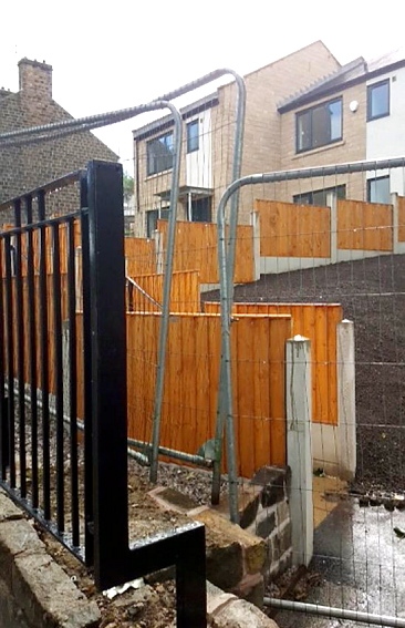 IN addition to metal railings, the new Huddersfield Road houses are surrounded by concrete posts and wooden panelled fences IN addition to metal railings, the new Huddersfield Road houses are surrounded by concrete posts and wooden panelled fences