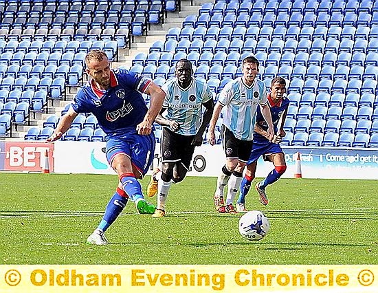 ON TARGET . . . Liam Kelly puts Latics in front from the penalty spot.
