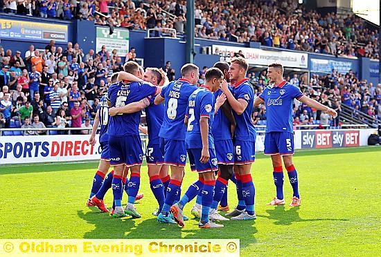 CELEBRATION TIME . . . team-mates congratulate penalty hot-shot Liam Kelly.
