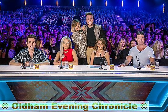 Nick, left co-stars Rita Ora, Cheryl Fernandez-Versini and Simon Cowell. Behind them are show presenters Caroline Flack and Olly Murs. Nick, left co-stars Rita Ora, Cheryl Fernandez-Versini and Simon Cowell. Behind them are show presenters Caroline Flack and Olly Murs.